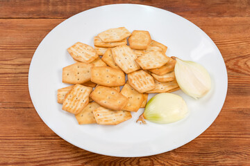 Savory crackers with onion addition and fresh onion on dish