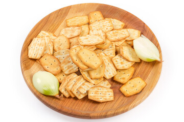 Savory crackers with onion addition, fresh onion on wooden dish
