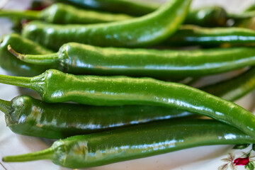 image with green hot peppers on a plate