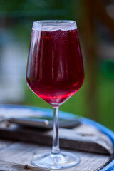 a glass of red wine and mineral water, also called Sprit.