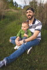 Naklejka na ściany i meble Father and his son spend time together. Parental love. Dad and his baby. Happy Father's Day! . Happy and smiling father and his son