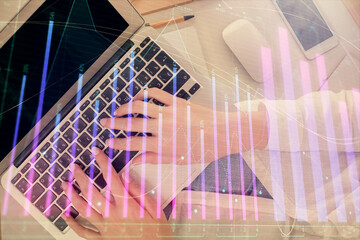 Double exposure of woman hands working on computer and forex chart hologram drawing. Top View. Financial analysis concept.