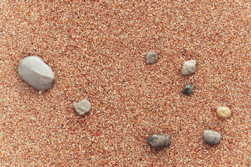 beach with yellow sand close-up, beautiful stones in the frame