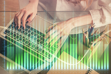 Double exposure of woman hands typing on computer and forex chart hologram drawing. Stock market invest concept.