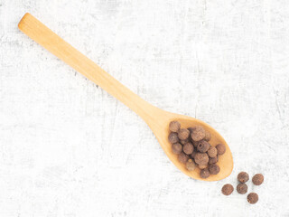 Spice Allspice (Jamaica pepper, Pimento) in wooden spoon, bunch on white concrete background. Macro. Flat lay. Healthy eating concept