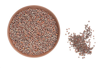 Mustard in clay plate and scattered in a heap on white background isolated. Healthy diet concept
