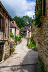 narrow street with stone houses in an idyllic French country village
