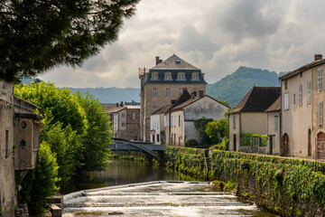 Fototapeta na wymiar downtown Saint-Cere with its historic riverside buildings and the La Bave river