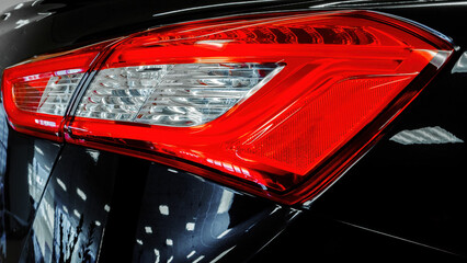 Taillight modern car. Close-up. Black, Red, White
