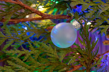 christmas tree with illuminated white ball, closeup