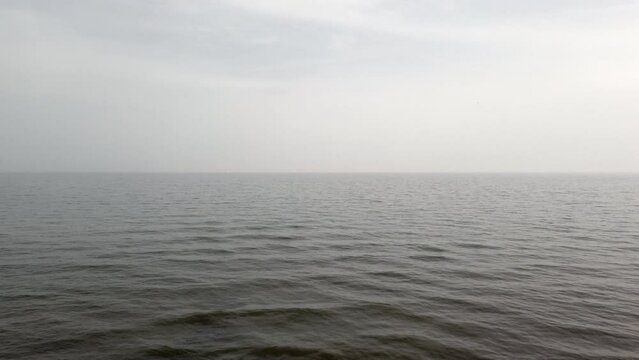 Baltic sea aerial view on a calm day under cloudy sky, 4k video footage