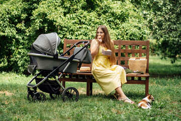 Plans and Diet for Breastfeeding Moms. Allergy in an infant child during breastfeeding the baby. Young mom eating fruits while walk with newborn baby in stroller. - obrazy, fototapety, plakaty