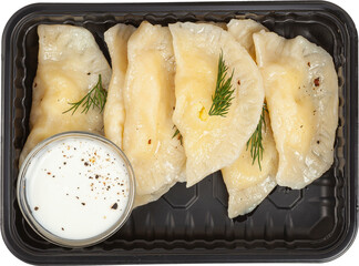 Dumplings with sour cream in a disposable rectangular plastic black lunch box top view on a white background