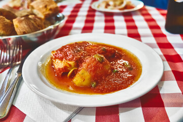Stockfish in Messina style. Cod stewed with tomatoes, caper, olive oil and potato. Traditional plate of Messina, Sicily, Italy
