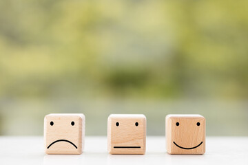 Select emotion or mood concept. Smile face or happy face which print screen on wooden cube block.