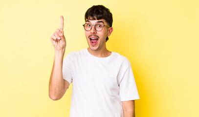 young adult hispanic man feeling like a happy and excited genius after realizing an idea,...