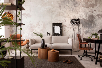 The stylish compostion at living room interior with design gray sofa, wooden coffee table, desk and elegant personal accessories. Loft and industrial interior. Home decor. Template. .