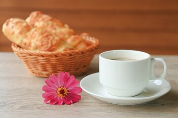 Coffee and bread on a bright day