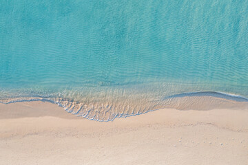 Relaxing aerial beach scene, summer vacation holiday template banner. Waves surf with amazing blue ocean lagoon, sea shore, coastline. Perfect aerial drone top view. Peaceful bright beach, seaside