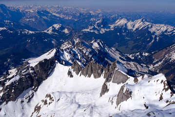 Aerial view over the Swiss Alps seen from Säntis peak at Alpstein Mountains on a sunny spring day. Photo taken April 19th, 2022, Säntis, Switzerland.