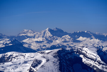 Aerial view over the Swiss Alps with Churfirsten and Toggenburg Valley seen from Säntis peak at Alpstein Mountains on a sunny spring day. Photo taken April 19th, 2022, Säntis, Switzerland.