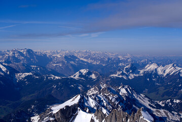 Aerial view over the Swiss Alps seen from Säntis peak at Alpstein Mountains on a sunny spring day. Photo taken April 19th, 2022, Säntis, Switzerland.