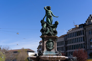 Fototapeta na wymiar Fountain named Broderbrunnen at square Lindenplatz in 1896, is a reminder of the times when the city was supplied with water from Lake Constance. Photo taken April 19th, 2022, St. Gallen, Switzerland.