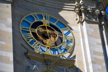 Close-up of clock of baroque collegiate church named St. Gallus und Otmar of City of St. Gallen on a sunny spring day. Photo taken April 19th, 2022, St. Gallen, Switzerland.	