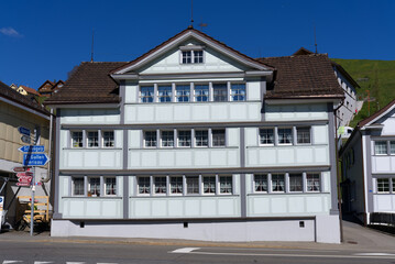 Facades of historic houses at village of Urnäsch on a sunny spring day. Photo taken April 19th, 2022, Urnäsch, Canton Appenzell Ausserrhoden, Switzerland.
