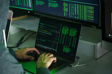 Hacker hands using laptop keyboard computer to code