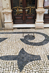 detail of the entrance door, the pavement and the facade of the Majestic café in Porto, Portugal