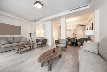 Living room with twin vintage wooden furniture, gray fabric three-seater sofas and light wooden...