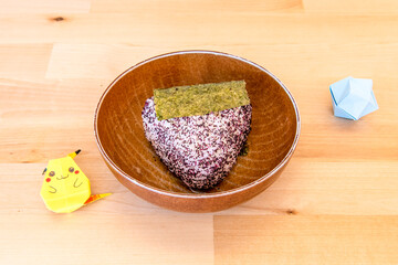 Onigiri or Omusubi is a Japanese dish that consists of a ball of rice filled with other...