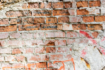 Damaged brick wall. Red brick. Brickwork on an old wall.
