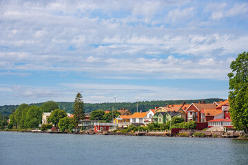 Fototapeta na wymiar Houses with a lake view on the shore of Lake Vättern in the town of Hjo in Sweden