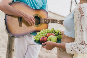 Cropped view portrait of attractive people best partners spending day good sunny weather playing guitar at beach picnic outdoors