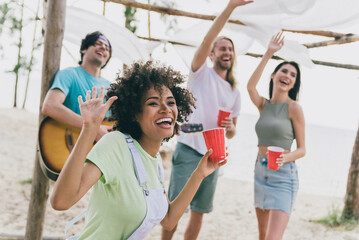 Portrait of attractive cheerful people friends buddy fellow having fun playing guitar good mood dancing waving hello outdoors