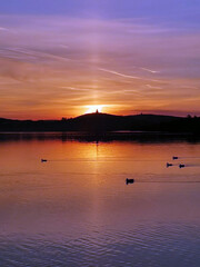 Watchtower on top of mountain in the rays of a scarlet sunset