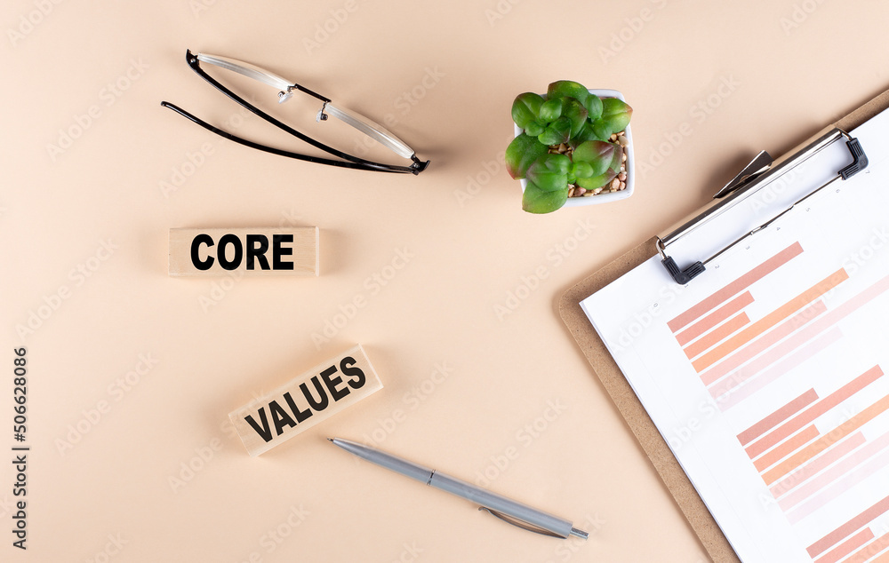 Poster core values text on wooden block with chart and glasses, business concept