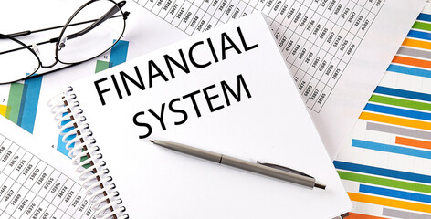 Notebook with text FINANCIAL SYSTEM . Diagram and white background,Business concept