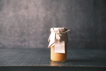 fresh honey in a glass jar with a paper empty label 