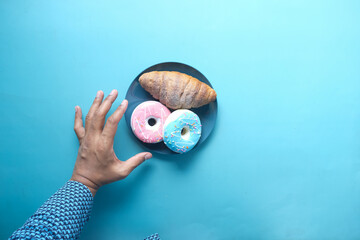 hand holding fresh donuts top view 