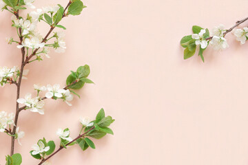 Obraz na płótnie Canvas Apple flowers on pink paper background. Pastel colors. Flat lay, top view. Spring flowers with green leaves. Floral pattern. Creative trend composition. Layout with blooming fruit tree. Greeting Card
