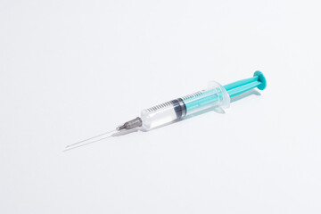 Medical syringe on a white background. A syringe for injection. The concept of health and beauty