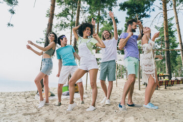Full length body size view of attractive cheerful friends friendship dancing having fun at bank...