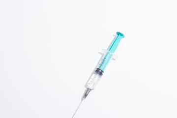 Fototapeta premium Medical syringe on a white background. A syringe for injection. The concept of health and beauty