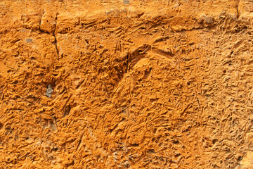 terracotta background. uneven rough stone surface of brick color