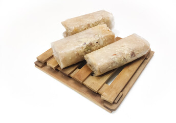 Closeup of South Indian traditional dish or Sweet pootharekelu made with rice floor, ghee and dry fruits. Isolated in a White background with selective focus and copy space for inscription. 