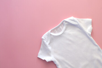 Mockup Flat Lay white bodysuit for on a pink background, for girls. Layout for the design. Baby clothes