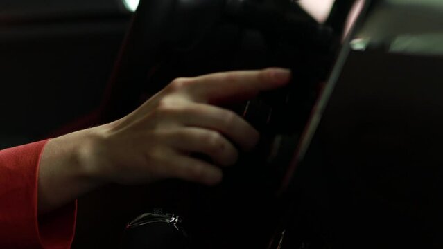 Woman touching digital dashboard while driving electric car 